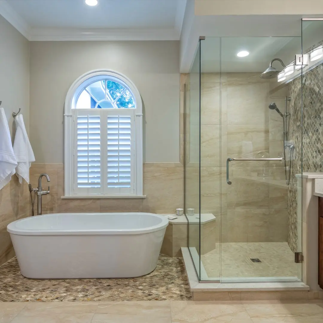 Remodeled bathroom with a soaking tub and glass shower