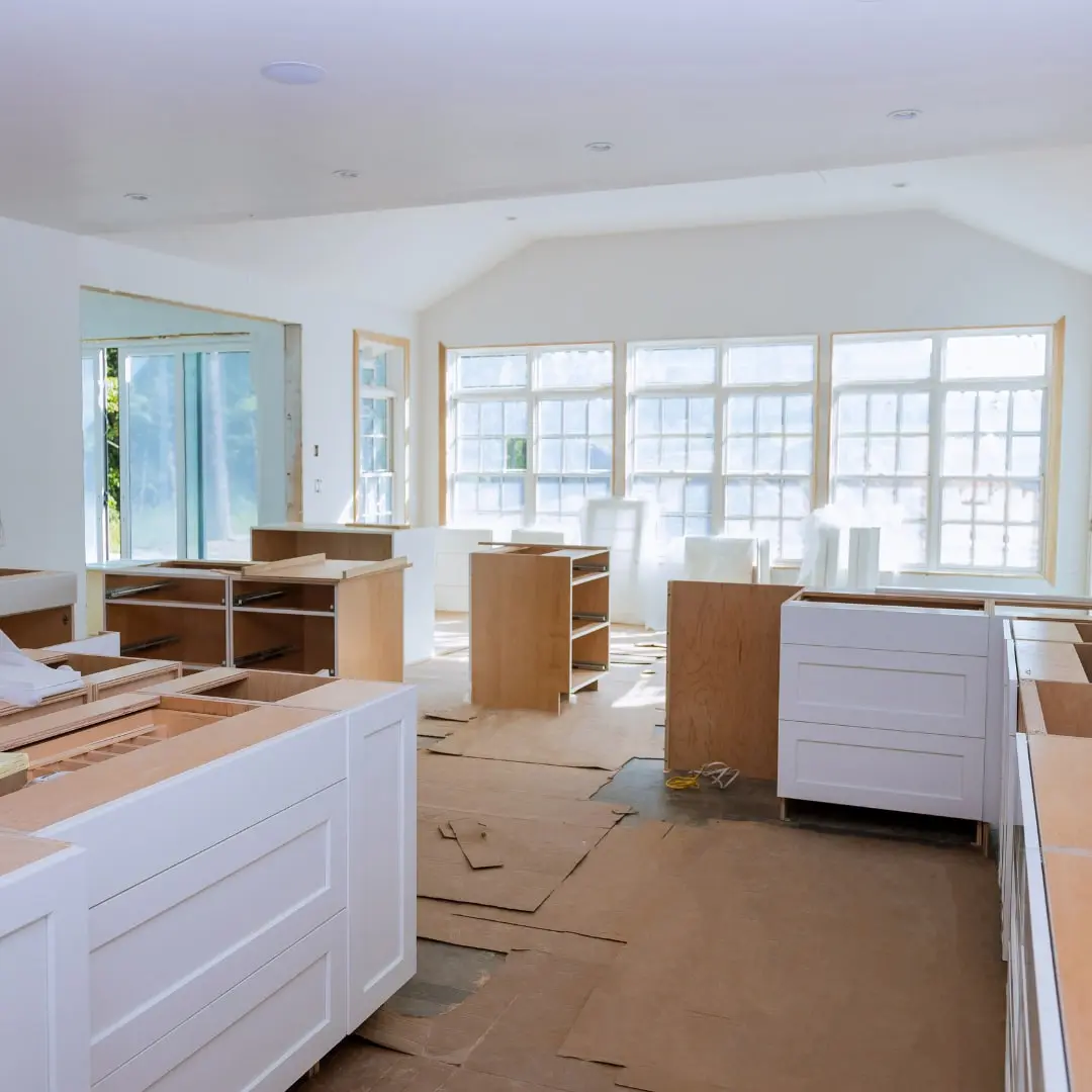 White kitchen cabinets partly installed