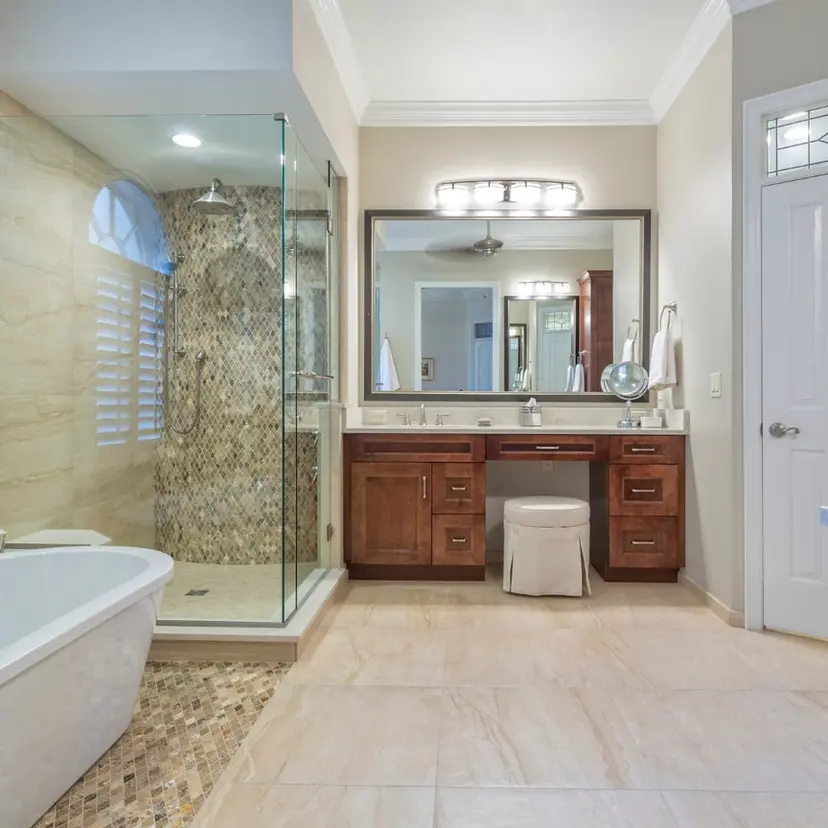 Bathroom with a glass shower, soaking tub, and wood vanity in a Central-area home