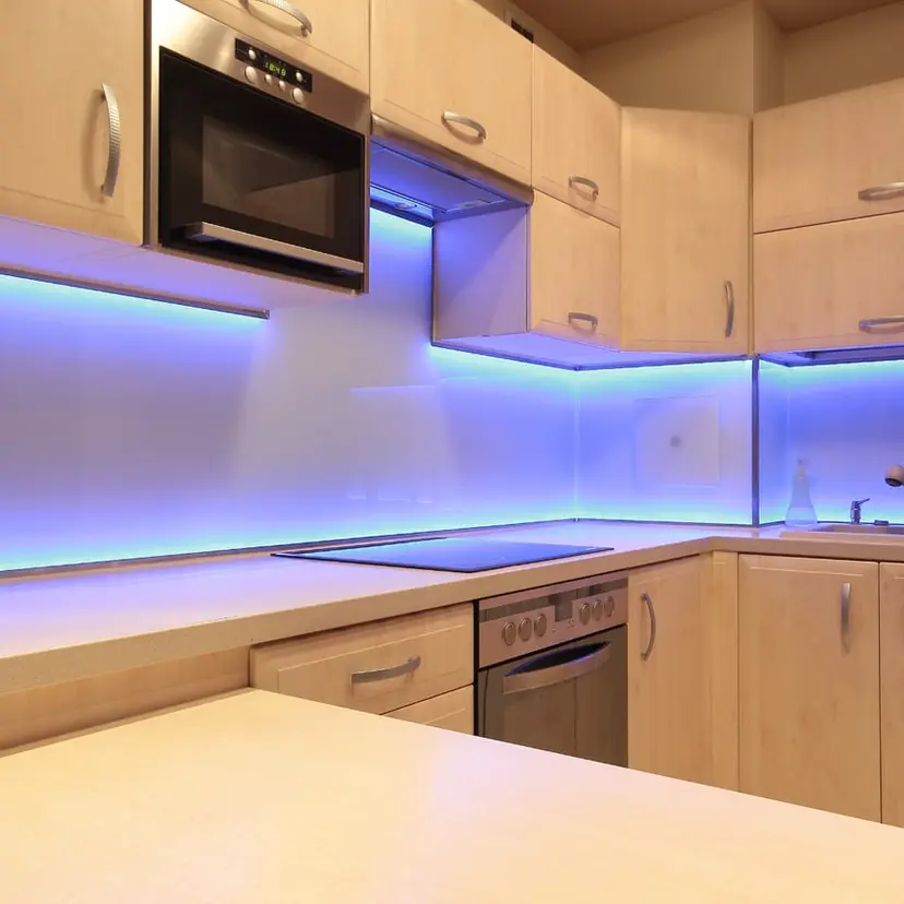 Finished kitchen with LED-lit cabinets and a warm wood finish