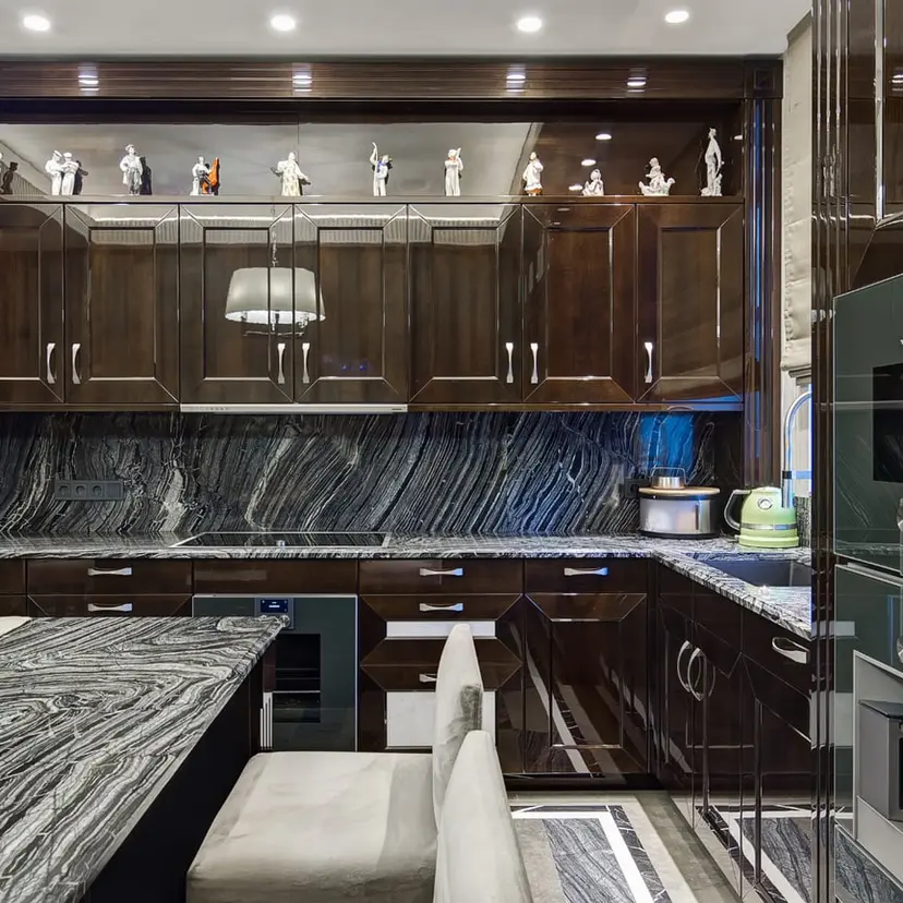 Dark wood kitchen cabinets with stone counters and backsplash