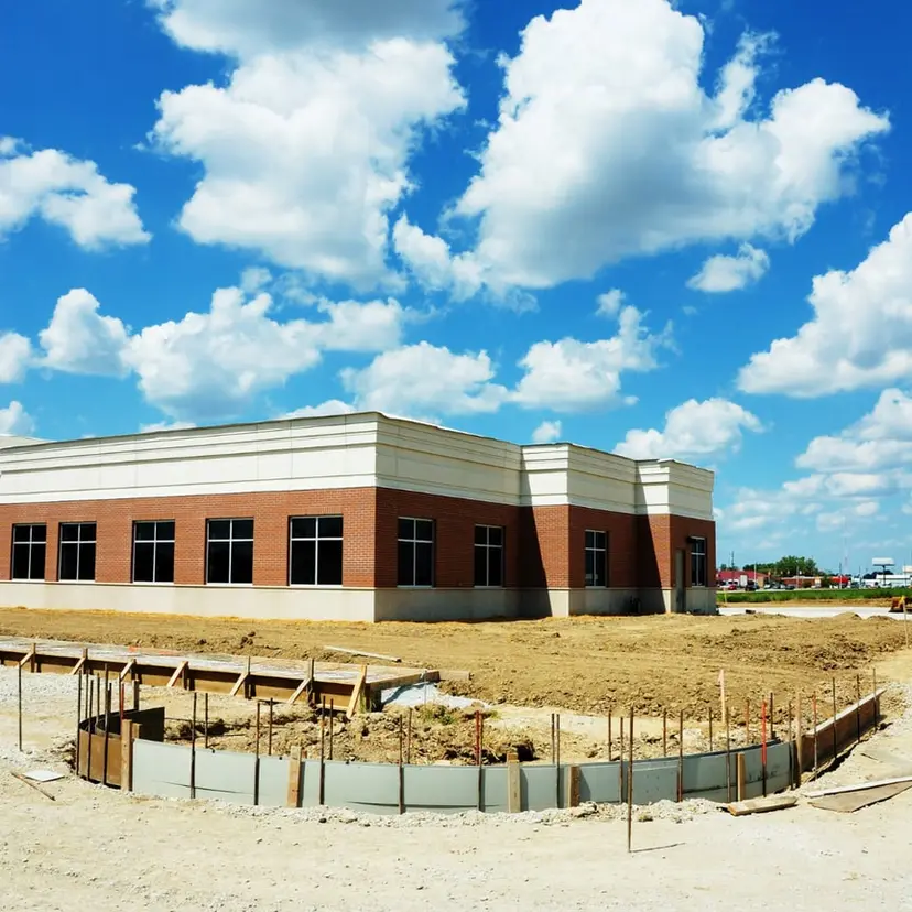 Brick single-story commercial building under construction, similar to business projects in Kenner