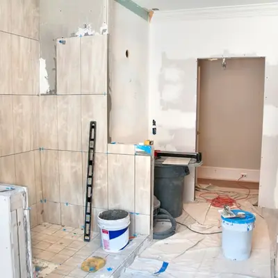 Bathroom stripped down to tile backer board in the middle of a repair