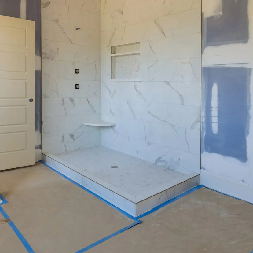 Tile shower walls and new shower pan going in during a renovation